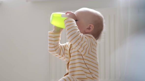 Portrait Drinking Baby at Home