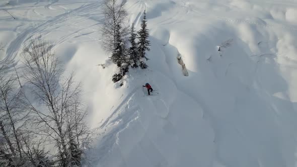 Skier Climbs a Snowy Hill