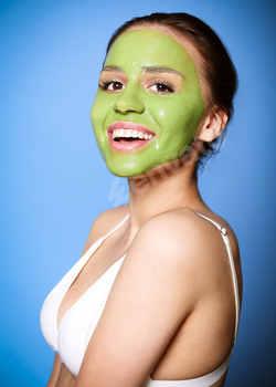 Cheerful woman with green mask