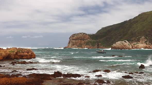 A commercial passenger vessel slowly investigates the Knysna Heads before turning back because of th