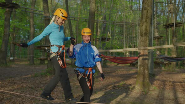 Woman slacklining in an adventure park