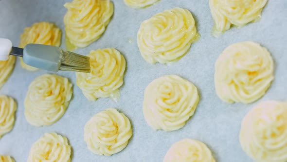 The Chef Greases the Potato Cookies with Oil with a Brush