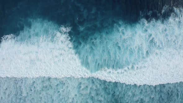 Slowmotion Top Down Aerial View of the Ocean Giant Waves Foaming and Splashing