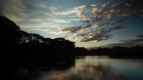 Clouds Reflected in Lake at Sunrise Time Lapse