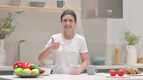 Young Indian Woman Showing Thumbs Up While Standing in Kitchen