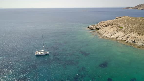 Aerial view of sailing boat in mediterranean, Alithini, Syros island, Greece.