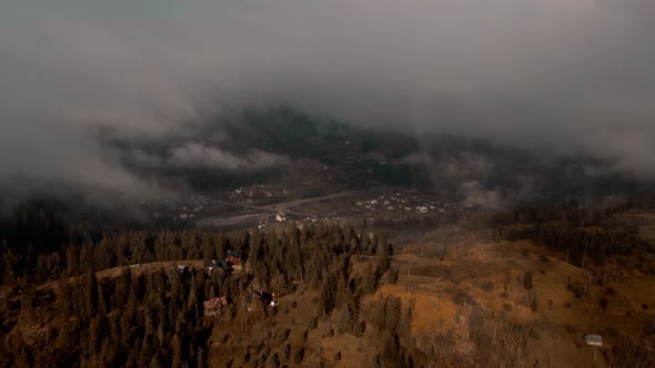 Aerial View Sea of Fog and Clouds Floating Rolling Over Village in Mountain Valley at Sunrise Golden