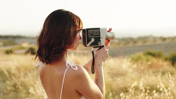 Woman Filming the Nature with Vintage Camera