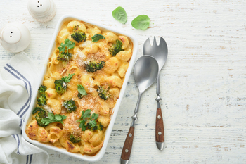 Casserole Mac and cheese. Baked Mac and cheese with broccoli, cream sauce and parmesan on white old