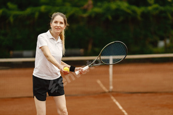 Female tennis player playing tennis on an open tennis court