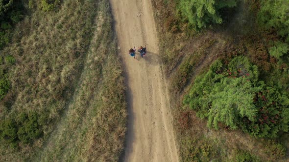 Tourists Walking Forest Road Exploring Nature Mountains Path Sunny Vacation Day