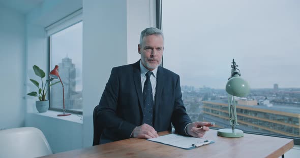 Mature adult businessman inside modern office interior