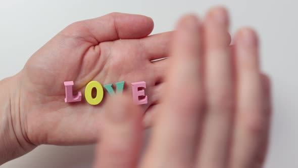 Word Love Colorful Letters Palm Hand Covering Hiding It