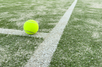 Tennis ball on grass tennis court