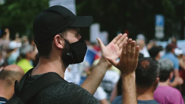 Masked Revolutionary Rebel Guy Claps and Applauds in Street Picket Crowd Strike