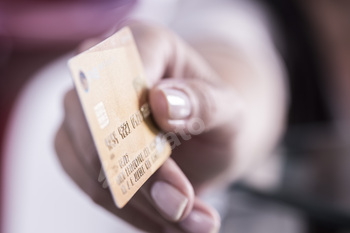 Hand holding a golden credit card