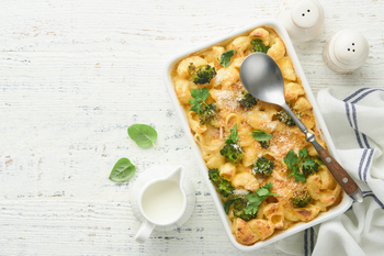 Casserole Mac and cheese. Baked Mac and cheese with broccoli, cream sauce and parmesan on white old