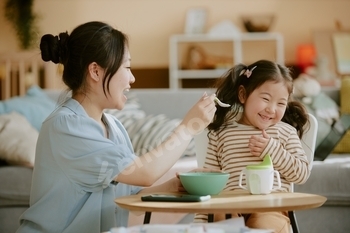 Mother Feeding her Daughter