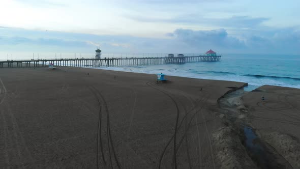 Gliding over the sand towards the Huntington Beach Pier in Surf City USA California at sunrise as pe