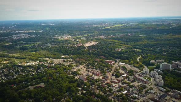 Cinematic drone shot panning across a massive city and countryside.