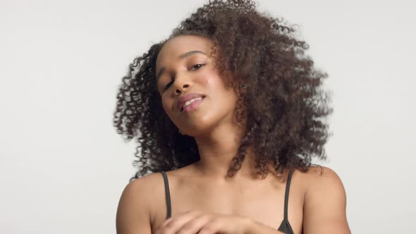 Closeup Portrait s of Young Mixed Race Model with Curly Hair in Studio with Natural Neutral Makeup