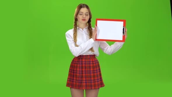 Girl Raises a Red Tablet with Paper. Green Screen