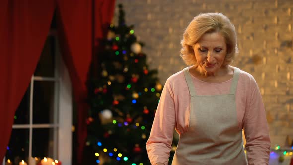 Retiree Lady Holding Cooking Dish With Traditional Biscuits, Xmas Tree Sparkling