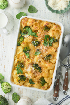 Casserole Mac and cheese. Baked Mac and cheese with broccoli, cream sauce and parmesan on white old