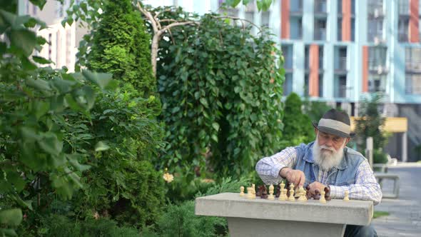 Alone Elderly Male Playing Chess with Himself