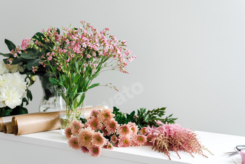 View of a desktop in a flower boutique full of flowers.