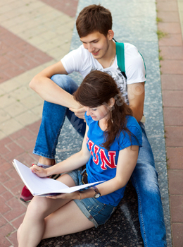 Students or teenagers with notebooks outdoors