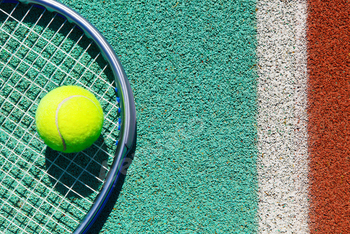 Close up of tennis racquet and ball on the tennis court