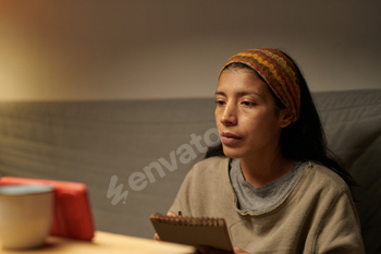 Contemplating Woman Sitting with Notebook