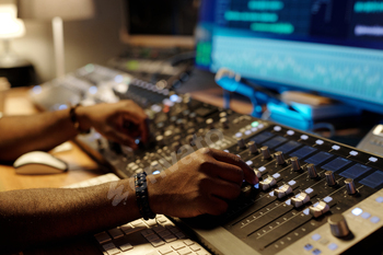 Adjusting Audio Levels on Professional Mixing Console