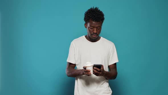 Portrait of Man Answering Phone Call on Smartphone in Studio