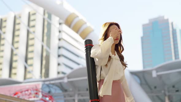 4K Asian business woman checking time on hand watch while walking in railway station in the morning.