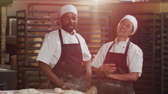 Animation of happy diverse male and female bakers looking at camera