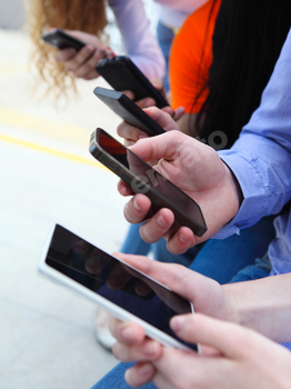 Group of a students chatting with their smartphones