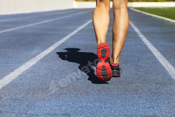 Athlete runner feet down stadium track