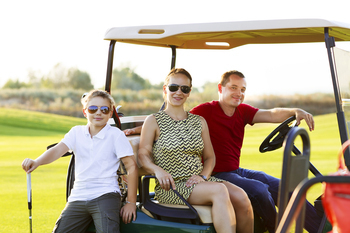 Family portrait in a cart at the golf course