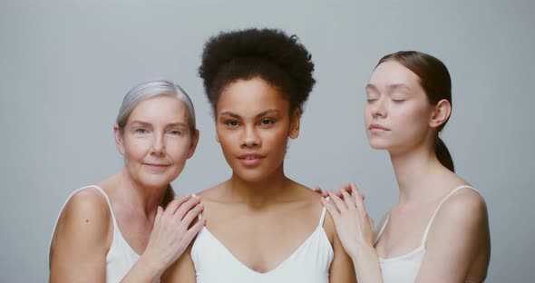 Caucasian Models with Large Age Differences Stand Beside AfricanAmerican Woman