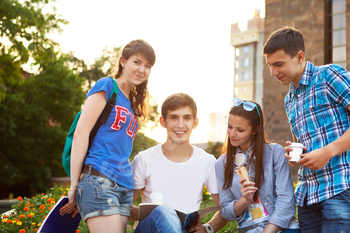 Group of students or teenagers with notebooks outdoors