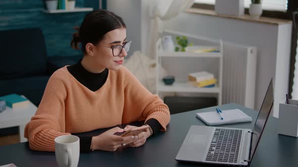 College Student Browsing Internet on Smartphone