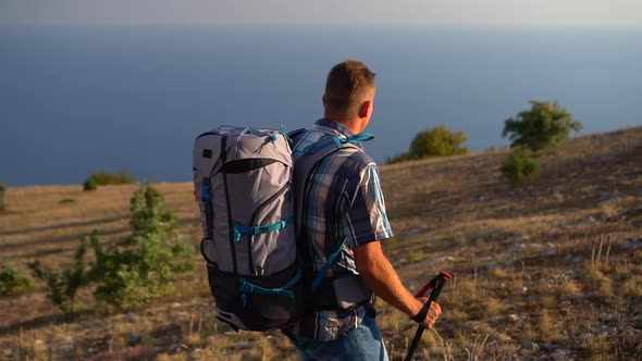 Hiker Man Travel to Explore the Mountain Rock By the Sea