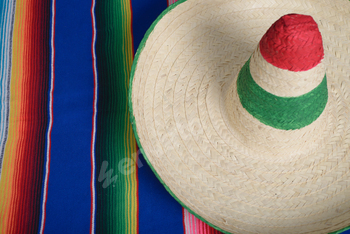 Mexican hat with the colors of the Mexican flag on a colorful serape.