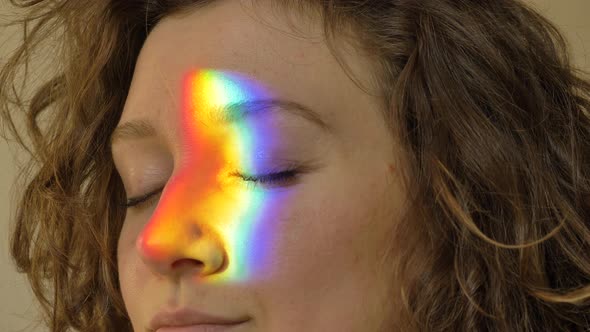 Brunette with Short Hair Opens Eyes and Rainbow Appears