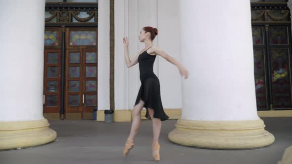 Side View of Elegant Slim Ballerina Walking on Tiptoes with Columns Passing at Front