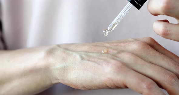 Oil Dripping on the Hand for Moisturizing and Skin Care