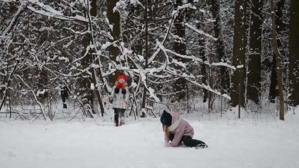 Two Little Girls Playing with Snow