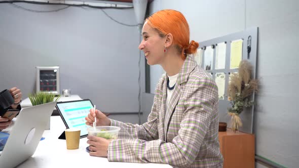 Woman having lunch with colleagues in office